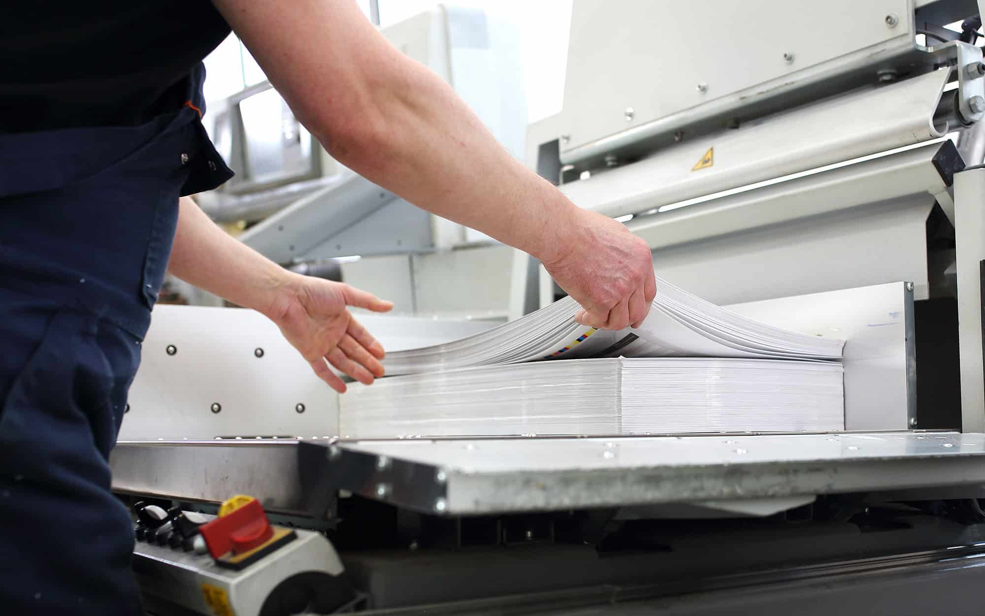 Paper Trimming On A Guillotine. Printing House